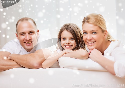 Image of smiling parents and little girl at home