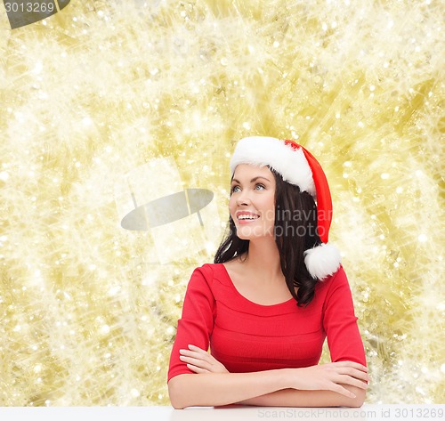 Image of smiling woman in santa helper hat