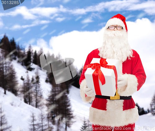 Image of man in costume of santa claus with gift box