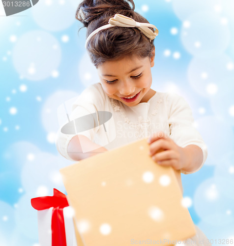 Image of smiling little girl with gift box