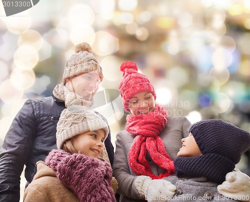 Image of happy family in winter clothes outdoors