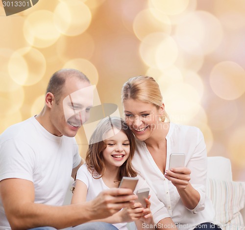 Image of happy family with smartphones
