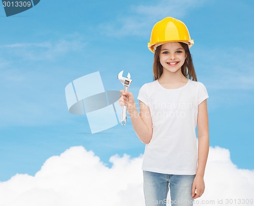 Image of smiling little girl in hardhat with wrench