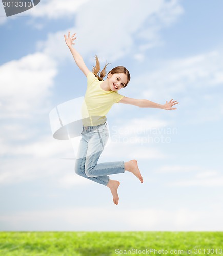 Image of smiling little girl jumping