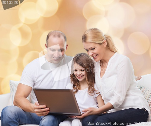 Image of smiling family with laptop