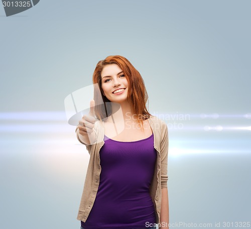 Image of smiling teenage girl showing thumbs up