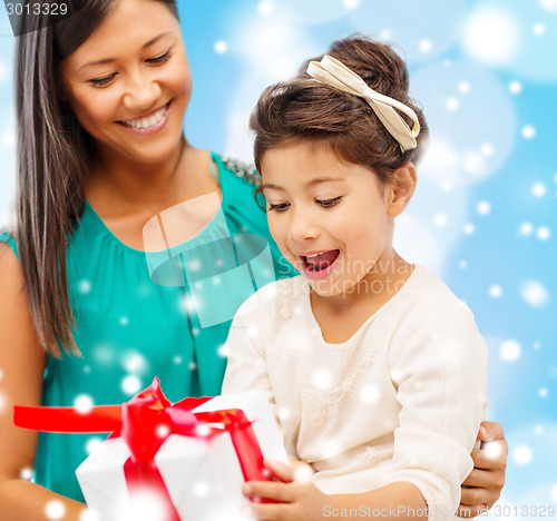 Image of happy mother and child girl with gift box