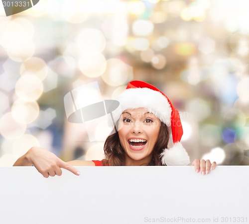 Image of woman in santa helper hat with blank white board