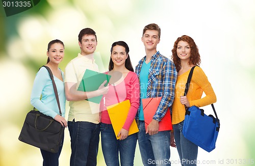 Image of group of smiling teenagers over green background