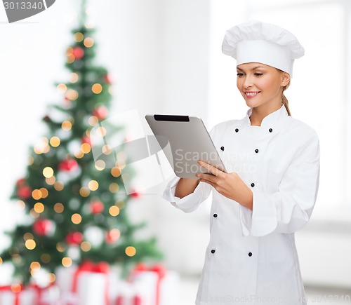 Image of smiling female chef with tablet pc computer