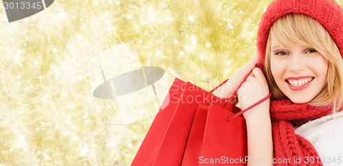 Image of smiling young woman with shopping bags
