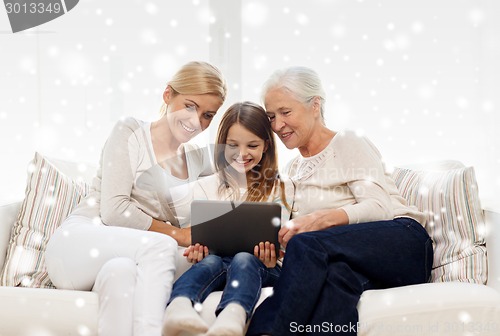 Image of smiling family with tablet pc at home