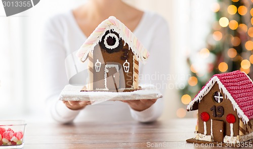 Image of close up of woman showing gingerbread house