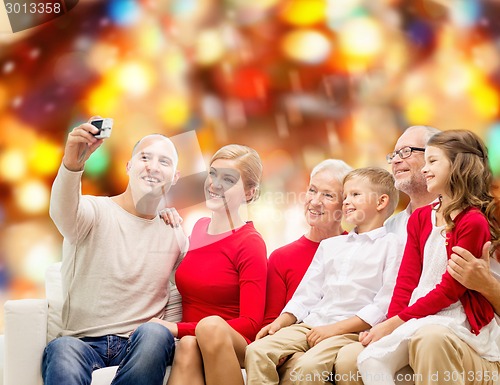 Image of smiling family with camera