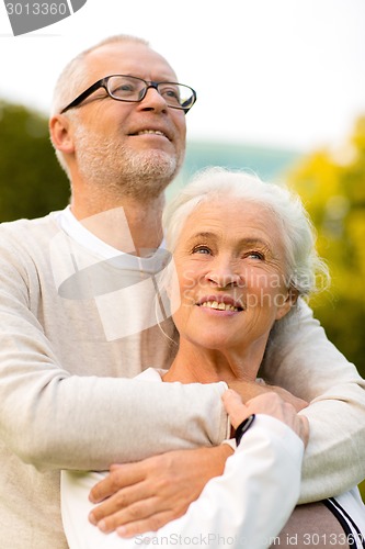 Image of senior couple hugging in park