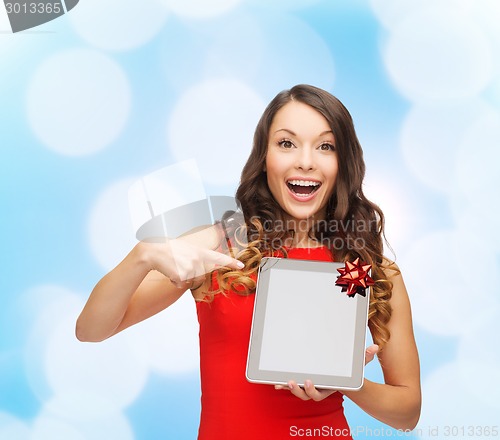 Image of smiling woman in red dress with tablet pc