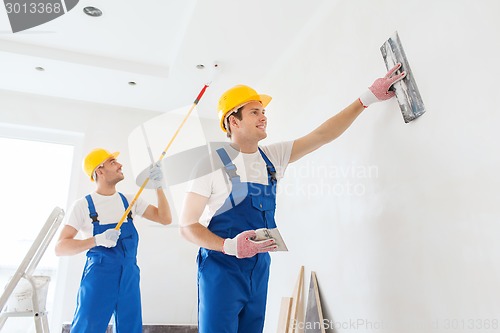 Image of group of builders with tools indoors