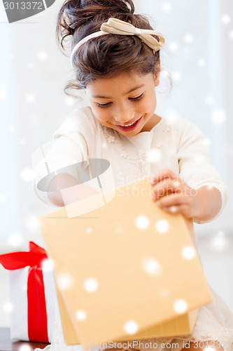 Image of smiling little girl with gift box