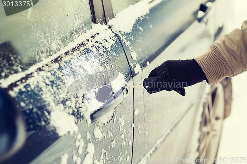 Image of closeup of man hand opening car with key