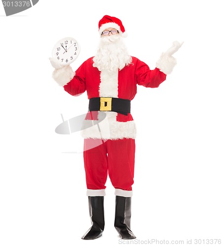 Image of man in costume of santa claus with clock