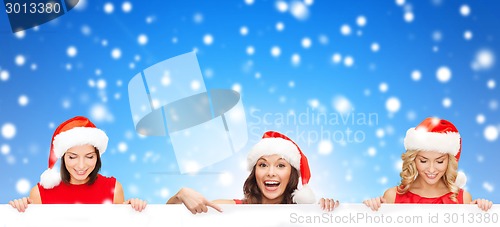 Image of women in santa helper hat with blank white board