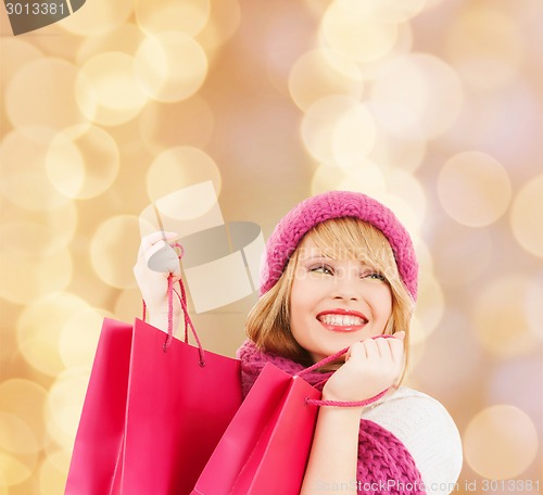 Image of smiling young woman with shopping bags