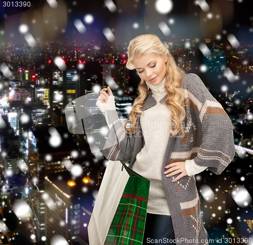 Image of smiling young woman with shopping bags