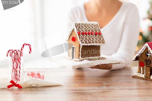 Image of close up of woman showing gingerbread house