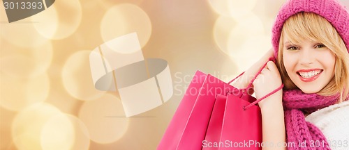Image of smiling young woman with shopping bags