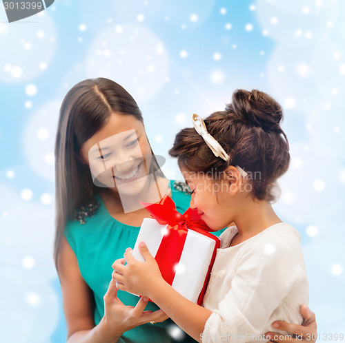 Image of happy mother and child girl with gift box