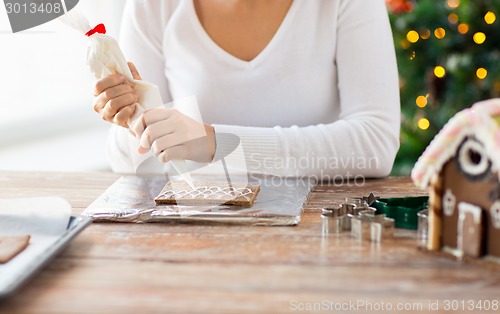 Image of close up of woman making gingerbread houses