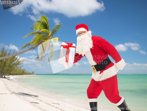 Image of man in costume of santa claus with gift box