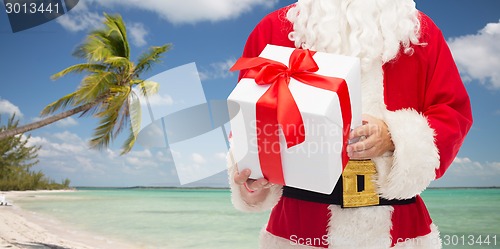 Image of man in costume of santa claus with gift box