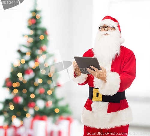 Image of man in costume of santa claus with tablet pc