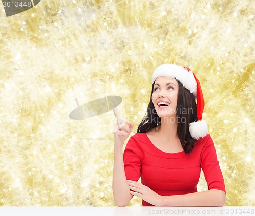 Image of smiling woman in santa helper hat