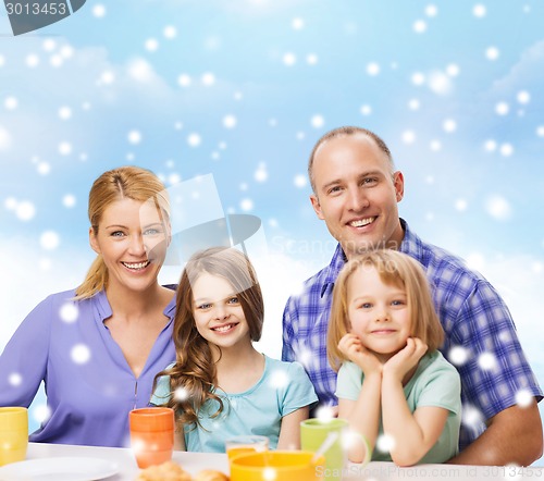 Image of happy family with two kids having breakfast