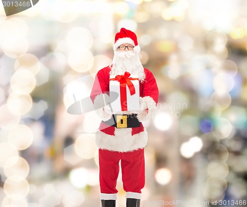 Image of man in costume of santa claus with gift box