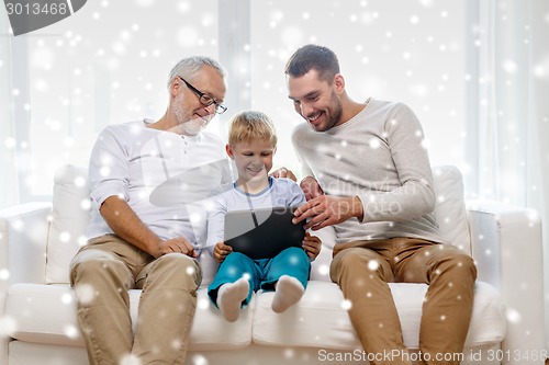 Image of smiling family with tablet pc at home