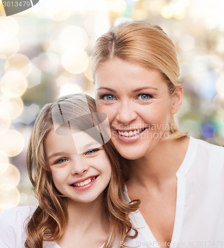 Image of smiling mother and little girl
