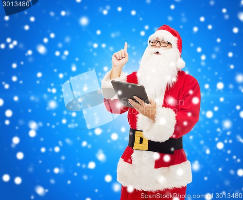 Image of man in costume of santa claus with tablet pc