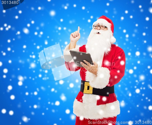 Image of man in costume of santa claus with tablet pc