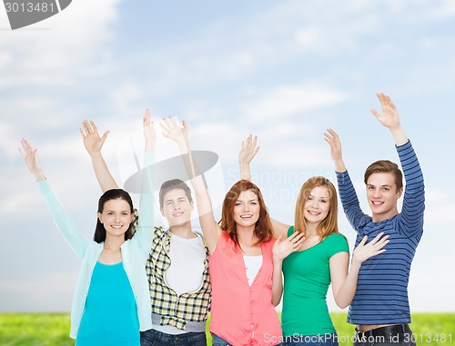 Image of group of smiling students waving hands