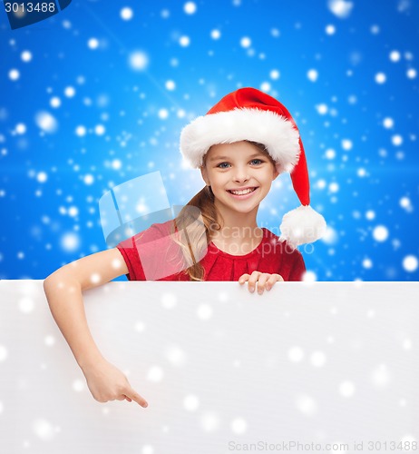 Image of girl in santa helper hat with blank white board