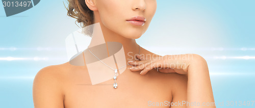 Image of woman wearing shiny diamond pendant