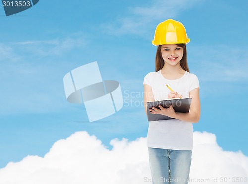 Image of smiling little girl in hardhat with clipboard