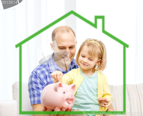 Image of happy father and daughter with big piggy bank