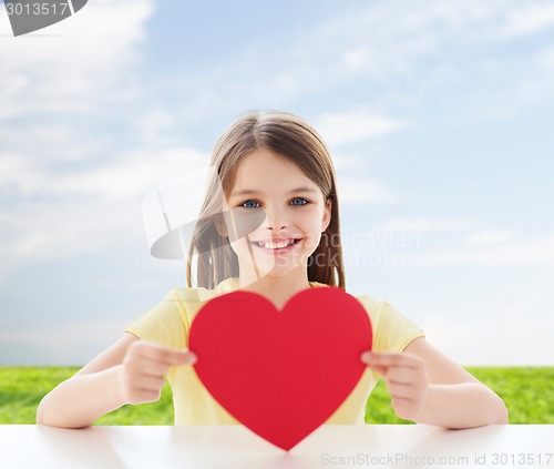 Image of beautiful little girl sitting at table