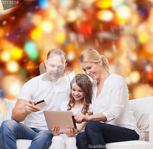 Image of happy family with tablet pc and credit card