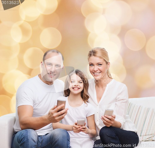 Image of happy family with smartphones