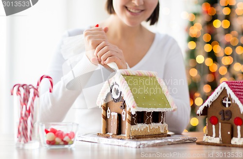 Image of close up of woman making gingerbread houses